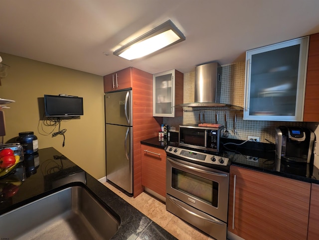 kitchen featuring wall chimney exhaust hood, sink, light tile patterned floors, appliances with stainless steel finishes, and tasteful backsplash