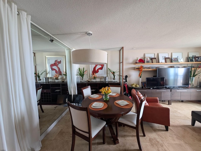 dining area featuring a textured ceiling