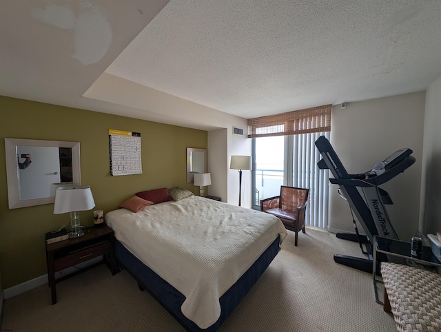 bedroom with ceiling fan, carpet, and a textured ceiling