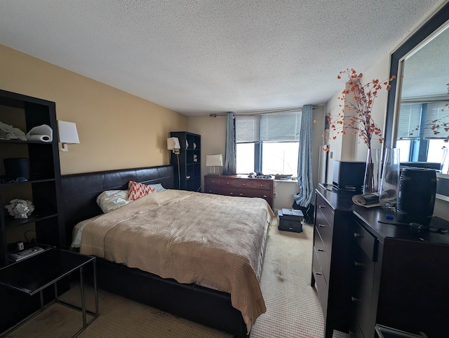 bedroom with light carpet and a textured ceiling