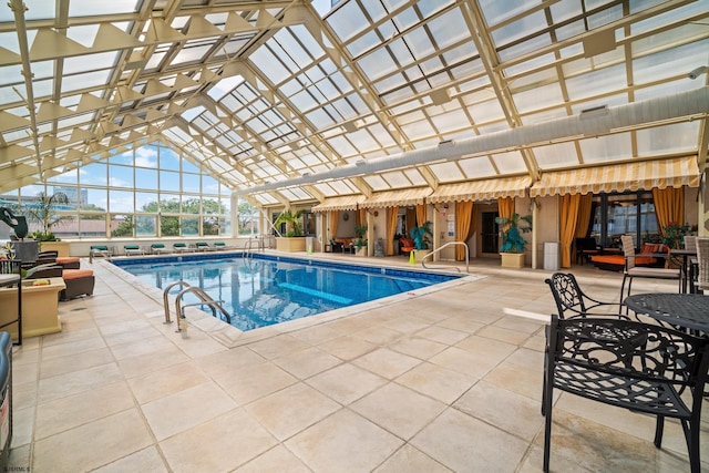 view of pool featuring a patio and glass enclosure