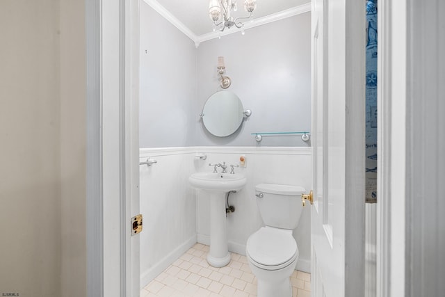 bathroom with a notable chandelier, toilet, crown molding, and tile patterned floors