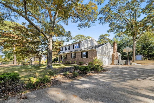 view of front of house featuring a storage shed and a garage