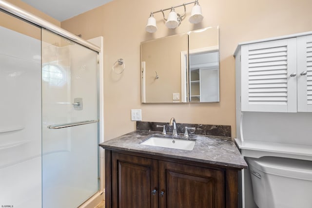 bathroom with vanity, toilet, and walk in shower