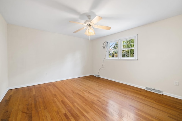 spare room with ceiling fan and wood-type flooring