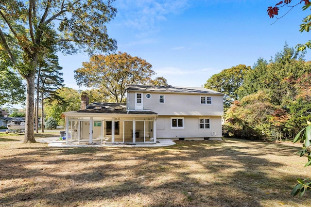 rear view of house featuring a patio and a lawn