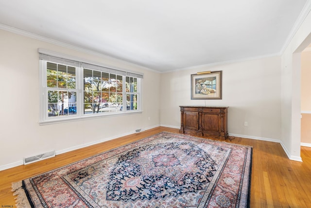 sitting room featuring crown molding and hardwood / wood-style flooring