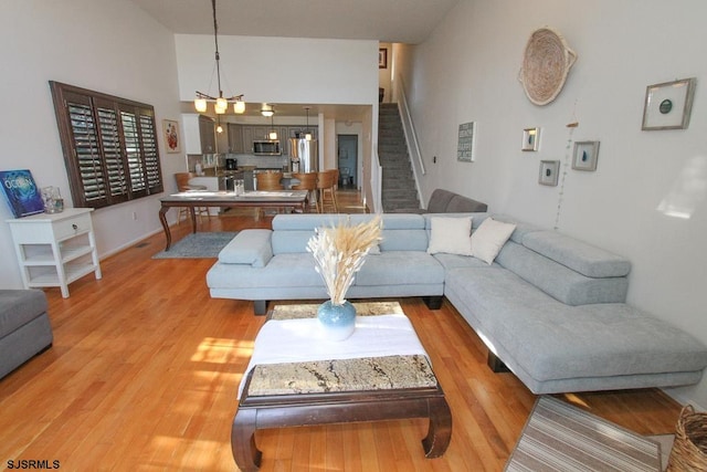 living room with hardwood / wood-style floors and high vaulted ceiling