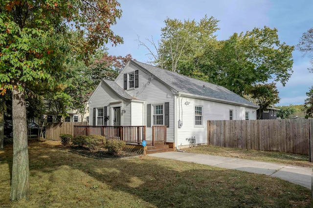 view of front of house featuring a front yard and a deck