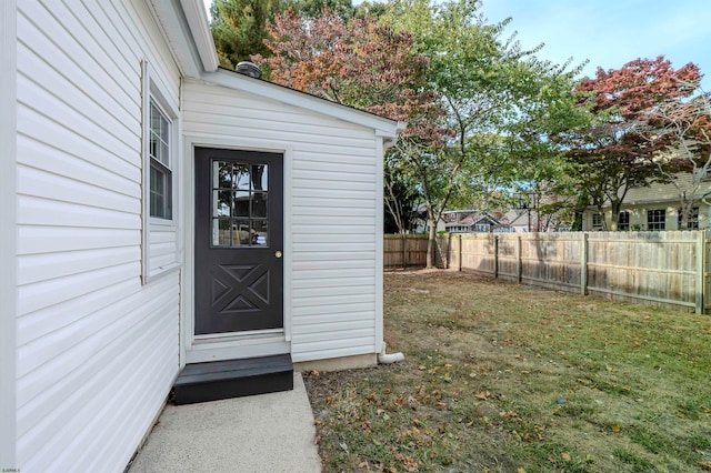 property entrance with a yard