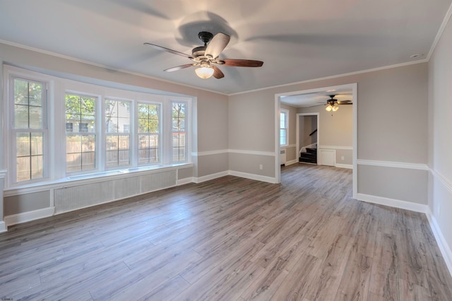 unfurnished room featuring crown molding, ceiling fan, and light hardwood / wood-style flooring