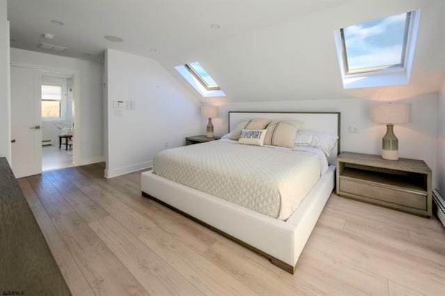 bedroom featuring light hardwood / wood-style floors and vaulted ceiling