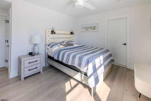 bedroom with light hardwood / wood-style floors and ceiling fan