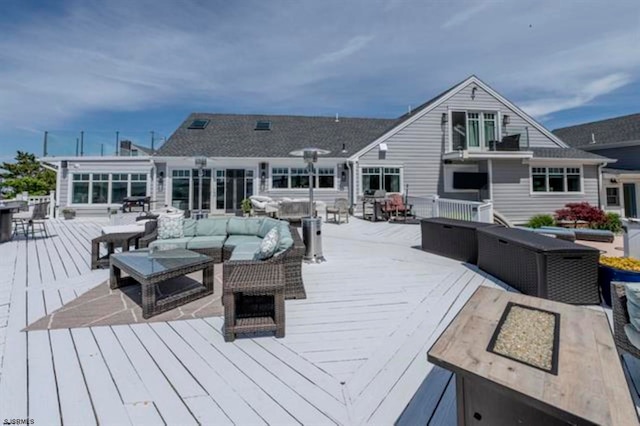 wooden terrace featuring outdoor lounge area