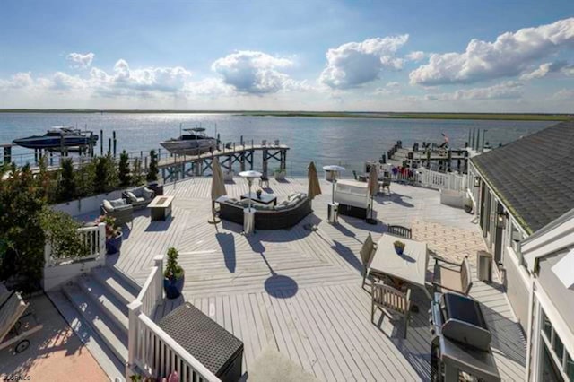 dock area with a deck with water view and an outdoor hangout area