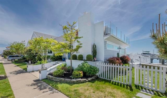 view of side of home with a yard