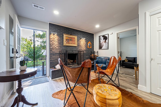 living room with light hardwood / wood-style floors and a fireplace