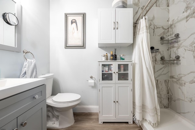 bathroom featuring vanity, toilet, hardwood / wood-style flooring, and a shower with curtain