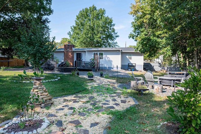 view of yard featuring a patio, a deck, and a fire pit