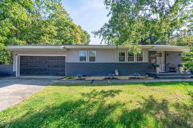 single story home featuring a garage and a front lawn