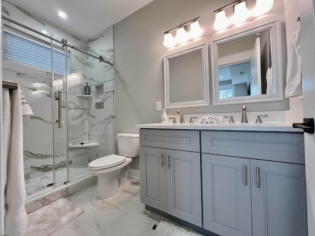 bathroom with vanity, toilet, and a shower with door