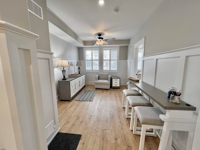 interior space featuring light hardwood / wood-style floors and ceiling fan