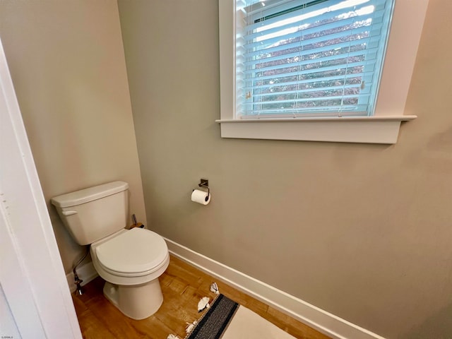 bathroom with hardwood / wood-style floors and toilet