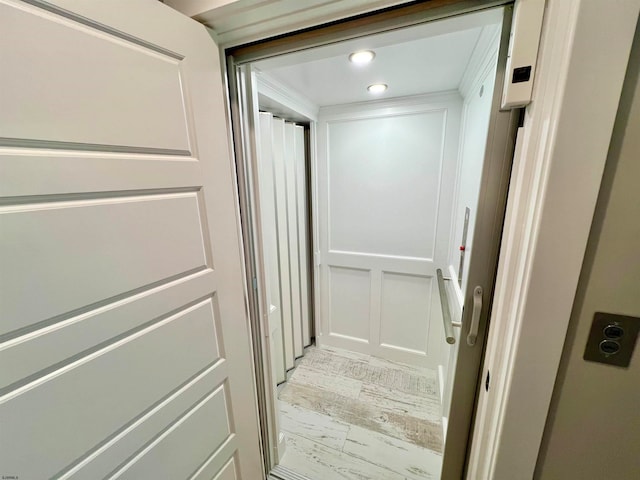 corridor with light hardwood / wood-style flooring