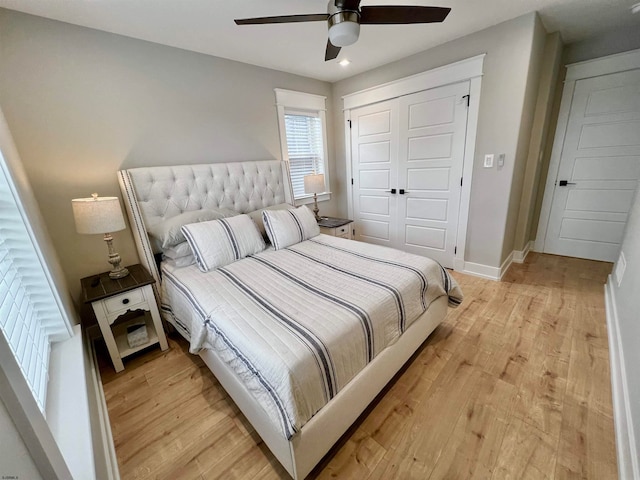 bedroom with a closet, ceiling fan, and light wood-type flooring