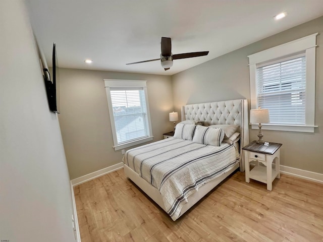 bedroom with light hardwood / wood-style flooring and ceiling fan