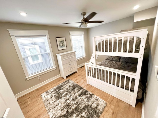 bedroom with light hardwood / wood-style floors and ceiling fan