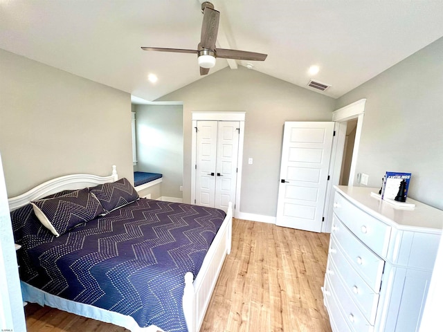 bedroom with light hardwood / wood-style flooring, a closet, lofted ceiling, and ceiling fan