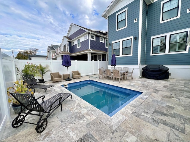 view of swimming pool with a patio area and a grill