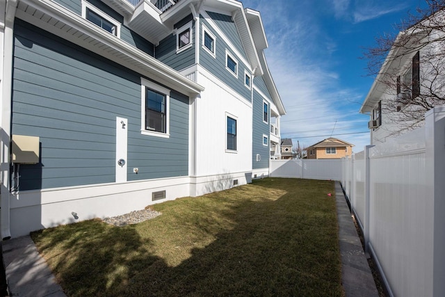 view of side of home featuring a yard