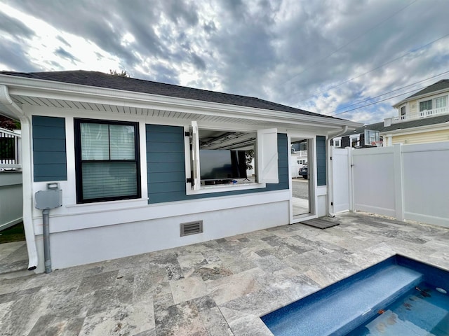 back of house with a patio