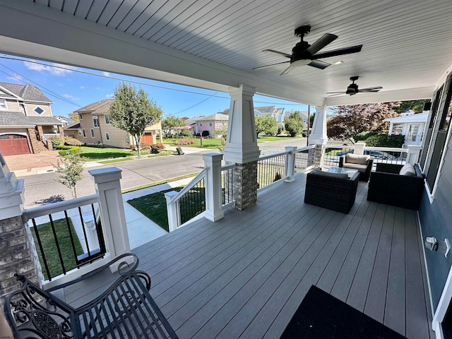 wooden deck featuring covered porch and ceiling fan