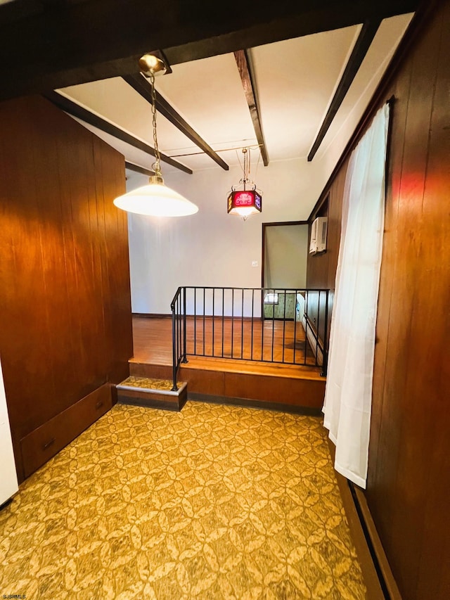 corridor with beamed ceiling and wood walls