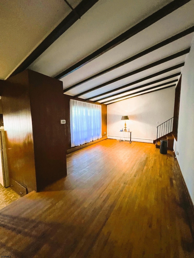 interior space featuring beamed ceiling and hardwood / wood-style floors