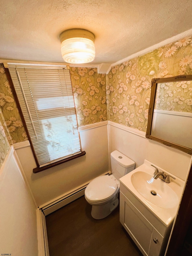 bathroom featuring toilet, a textured ceiling, vanity, and a baseboard radiator