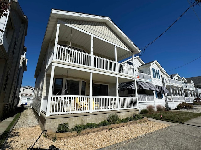 view of front of home featuring a porch and a balcony