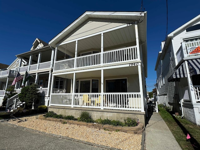 view of front of property with covered porch and a balcony