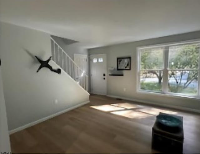 unfurnished living room with dark hardwood / wood-style flooring