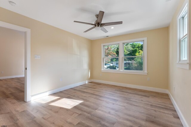 unfurnished room featuring light hardwood / wood-style floors and ceiling fan