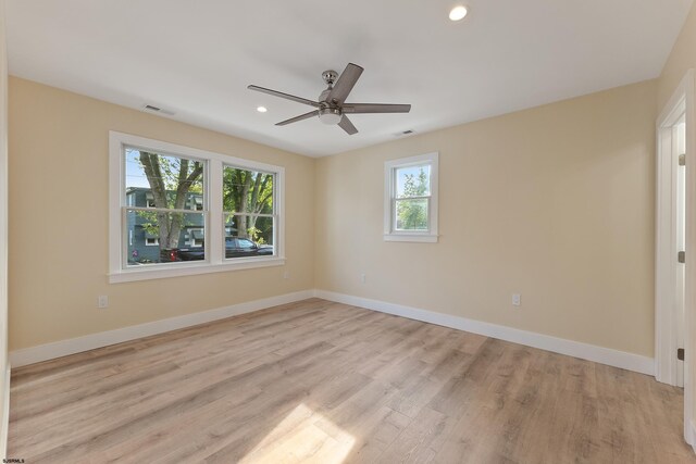 empty room with light hardwood / wood-style floors and ceiling fan