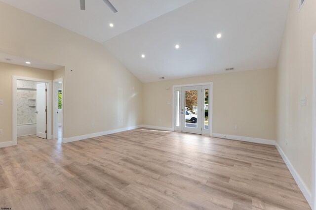 unfurnished living room with light hardwood / wood-style flooring, high vaulted ceiling, and ceiling fan