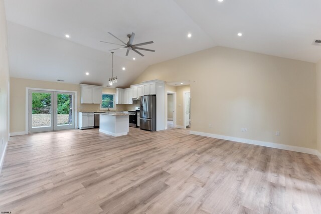 kitchen featuring light hardwood / wood-style floors, appliances with stainless steel finishes, a kitchen island, and white cabinets