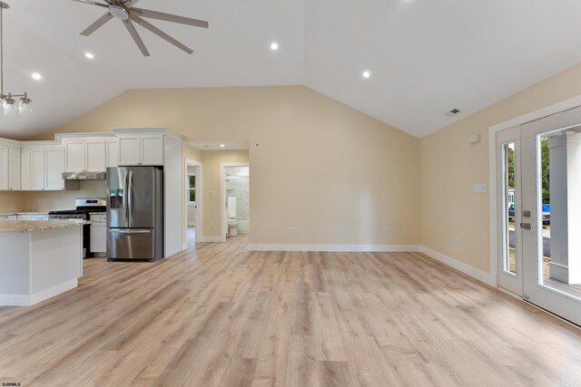 kitchen with lofted ceiling, white cabinets, light hardwood / wood-style flooring, and stainless steel appliances