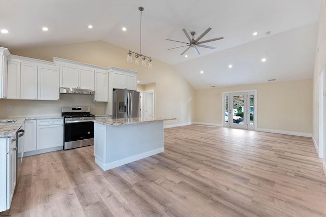 kitchen with white cabinets, vaulted ceiling, light hardwood / wood-style flooring, stainless steel appliances, and a center island