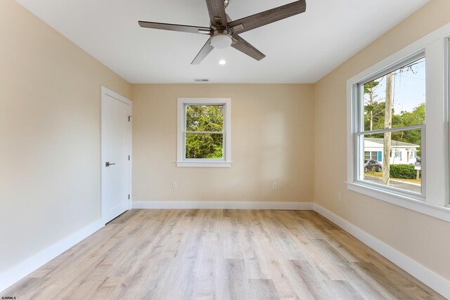 spare room with light hardwood / wood-style floors and ceiling fan