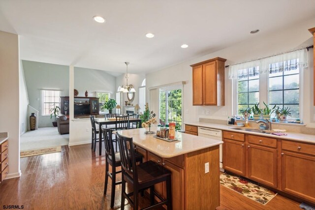 kitchen featuring dishwasher, a healthy amount of sunlight, sink, and a kitchen island